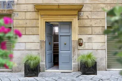 a door of a building with two potted plants at BeSecret Belsiana in Rome
