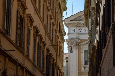 a street sign in an alley between buildings at BeSecret Belsiana in Rome