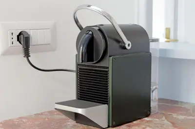 a fax machine with a cord plugged into a wall at Modern retreat with Spectacular St Peter's views in Rome