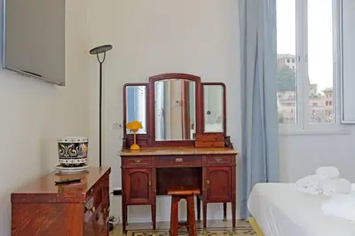 a bedroom with a dresser with a mirror on it at Modern retreat with Spectacular St Peter's views in Rome