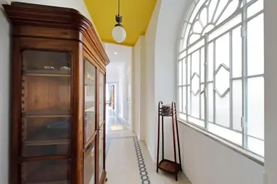 a hallway with a wooden cabinet and a window at Modern retreat with Spectacular St Peter's views in Rome