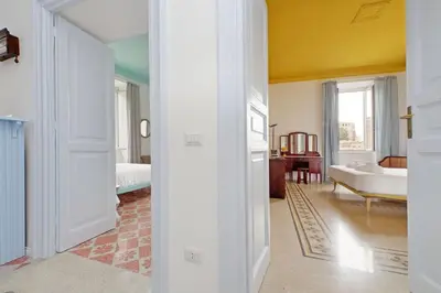 a room with a bedroom with a bed and a desk at Modern retreat with Spectacular St Peter's views in Rome