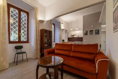 a living room with a couch and a table at GuestHost Cozy Flat X4 - 450m to Vatican City! in Rome