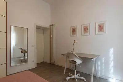 a white room with a desk and a mirror at GuestHost Cozy Flat X4 - 450m to Vatican City! in Rome