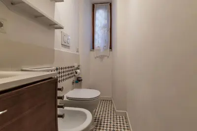 a small bathroom with a toilet and a sink at GuestHost Cozy Flat X4 - 450m to Vatican City! in Rome