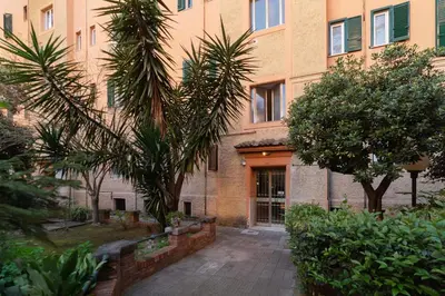 a building with palm trees in front of it at GuestHost Cozy Flat X4 - 450m to Vatican City! in Rome