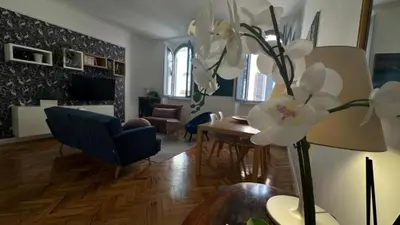 a living room with a table and white flowers in a vase at La bella vita Navona in Rome