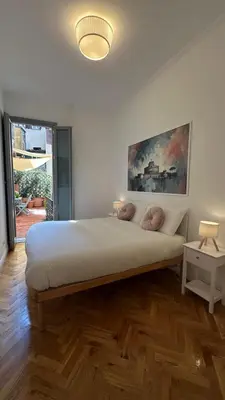 a bedroom with a large bed and a large window at La bella vita Navona in Rome