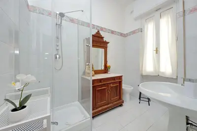 a white bathroom with a shower and a sink at 4BNB - Annibaliano Metro Apartment in Rome