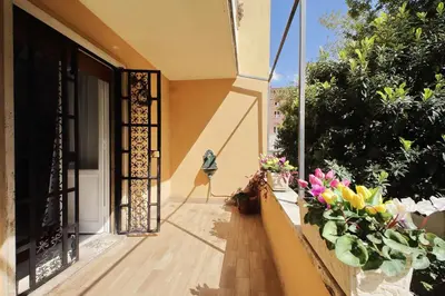 an open door to a balcony with flowers at 4BNB - Annibaliano Metro Apartment in Rome
