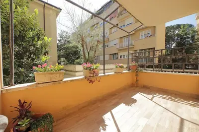 an apartment balcony with potted plants and windows at 4BNB - Annibaliano Metro Apartment in Rome