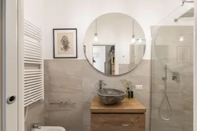 a bathroom with a sink and a mirror at iFlat Stylish & Cozy Vatican Peaceful Gem in Rome