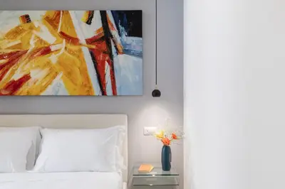 a bedroom with a painting above a bed at iFlat Stylish & Cozy Vatican Peaceful Gem in Rome