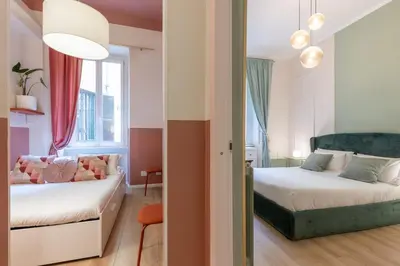 a bedroom with a bed and a couch in a room at The 38 Home Exclusive - Homkeey Apartments in Rome