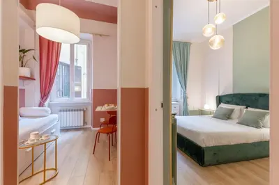 a hotel room with a bed and a table at The 38 Home Exclusive - Homkeey Apartments in Rome