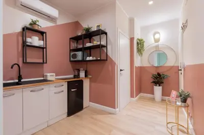 a kitchen with pink walls and a sink at The 38 Home Exclusive - Homkeey Apartments in Rome