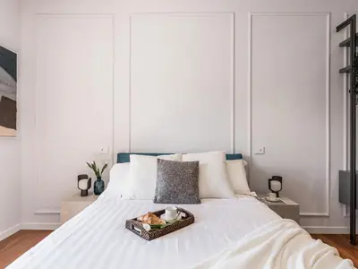 a white bed with a tray of food on it at The Best Rent - Prestigious multi-bedroom apartment overlooking St. Peter’s in Rome
