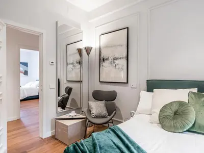 a bedroom with a bed and two chairs at The Best Rent - Prestigious multi-bedroom apartment overlooking St. Peter’s in Rome