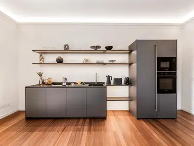 a kitchen with a stainless steel refrigerator and a hardwood floor at The Best Rent - Prestigious multi-bedroom apartment overlooking St. Peter’s in Rome