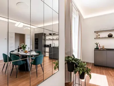 a dining room with a black table and green chairs at The Best Rent - Prestigious multi-bedroom apartment overlooking St. Peter’s in Rome