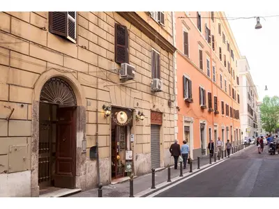 a city street with people walking down a street at Dimora Vaticano Rome Apartments in Rome