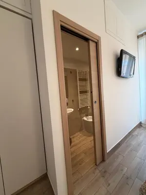 a door leading to a bathroom with a tub at Dimora Vaticano Rome Apartments in Rome