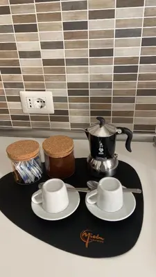 a tea pot and saucers on a tray on a counter at Dimora Vaticano Rome Apartments in Rome
