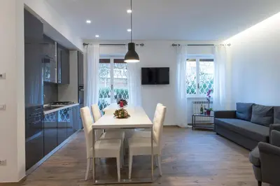 a kitchen and living room with a table and chairs at Boba's House, Rome in Rome