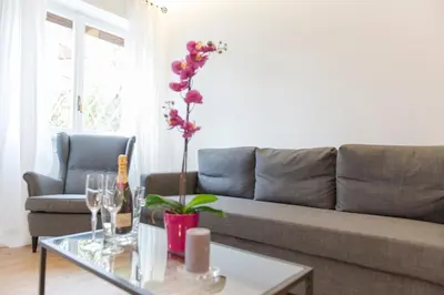 a living room with a couch and a table with a plant at Boba's House, Rome in Rome