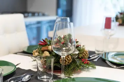 a table with a wine glass and a christmas centerpiece at Boba's House, Rome in Rome