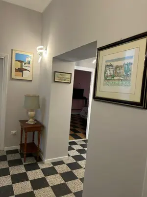 a hallway with a table and a picture on a wall at GiusPa casa in Rome
