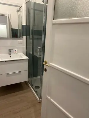 a bathroom with a shower and a glass door at GiusPa casa in Rome