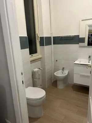 a bathroom with a toilet and a sink at GiusPa casa in Rome