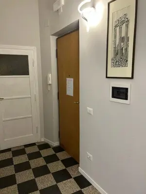 a hallway with a door and a checkered floor at GiusPa casa in Rome