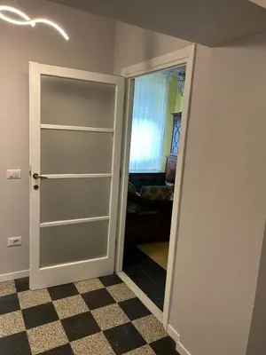 a room with a door and a room with a checkered floor at GiusPa casa in Rome