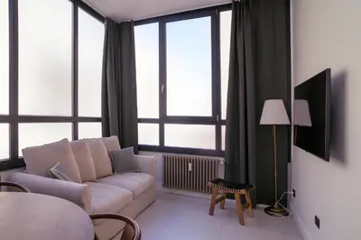 a living room with a couch and some windows at La Terrazza di Ermini in Rome