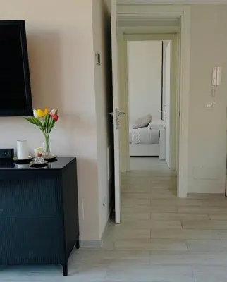 a hallway with a room with a bed and a television at Enzo House in Rome