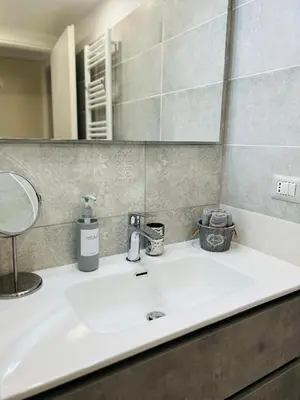 a bathroom with a sink and a mirror at Enzo House in Rome
