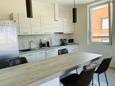 a kitchen with a large wooden table and chairs at Enzo House in Rome