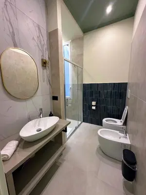 a bathroom with a sink and a toilet and a mirror at Mia House Prestige in Rome