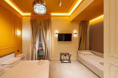 a hotel room with two beds and a chandelier at Mia House Prestige in Rome