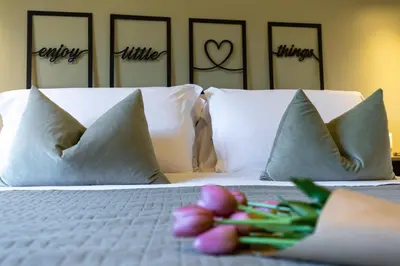 a bedroom with a bed with pillows and flowers on it at Oasis house Trastevere in Rome
