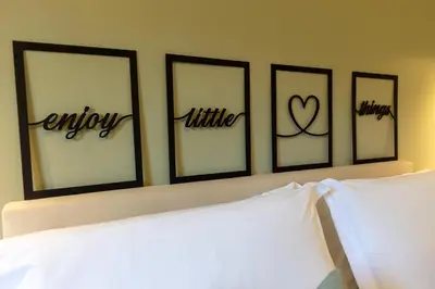 a bedroom with four pictures on the top of a bed at Oasis house Trastevere in Rome