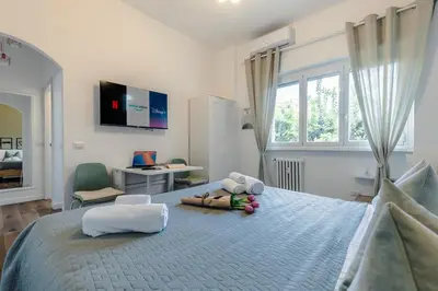 a bedroom with a large bed with a person laying on it at Oasis house Trastevere in Rome
