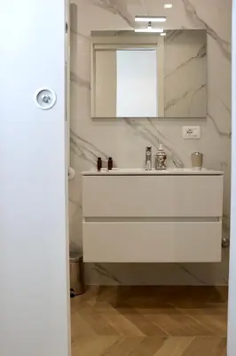 a bathroom with a sink and a mirror at Alessi Home Pigneto in Rome