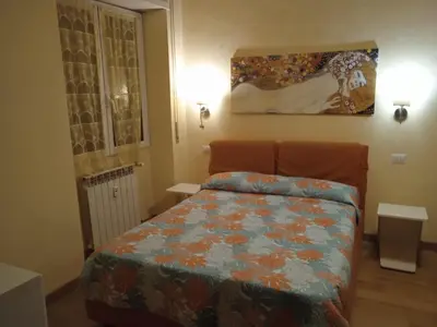 a bedroom with a bed and a painting on the wall at Alloggio turistico Artù in Rome