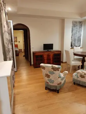 a living room with a tv and a chair and a table at Alloggio turistico Artù in Rome
