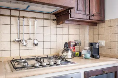 a kitchen counter with a stove top in a kitchen at Vatican Art Apartment in Rome