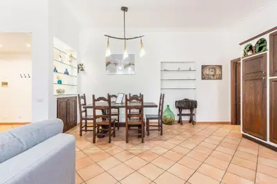 a living room with a dining room table and chairs at Vatican Art Apartment in Rome