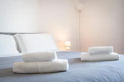 two white pillows sitting on top of a bed at Vatican Art Apartment in Rome